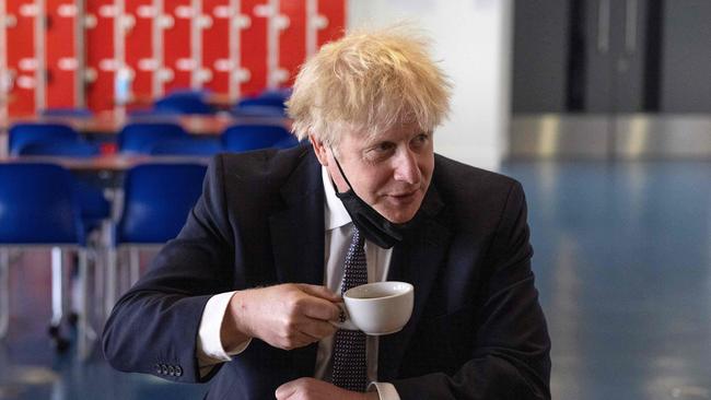 Boris Johnson takes a brew at King Solomon Academy in London on Thursday. Picture: AFP