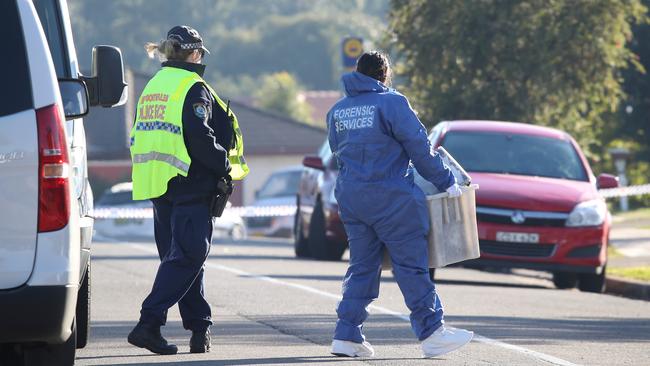 Police at the crime scene on the morning after the beheading death of Rita Camilleri at her home in St Clair. Picture: David Swift.