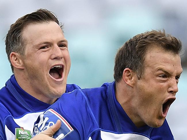 Josh Morris of the Bulldogs (right) celebrates with brother Brett (left) after scoring a try during the Round 3 NRL match between the Canterbury-Bankstown Bulldogs and the Penrith Panthers at ANZ Stadium in Sydney, Friday, March 23, 2018. (AAP Image/Dan Himbrechts) NO ARCHIVING, EDITORIAL USE ONLY