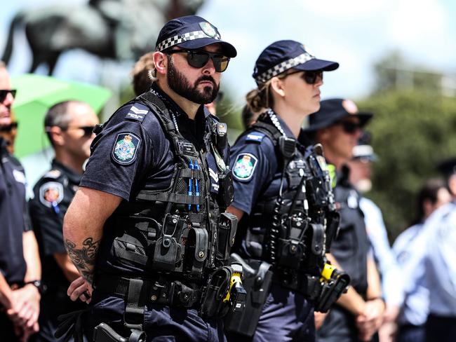 Members of the Queensland police service watch the Queensland Police Memorial Service for Constable Rachel McCrow and Constable Matthew Arnold from King George Square. Picture: Zak Simmonds