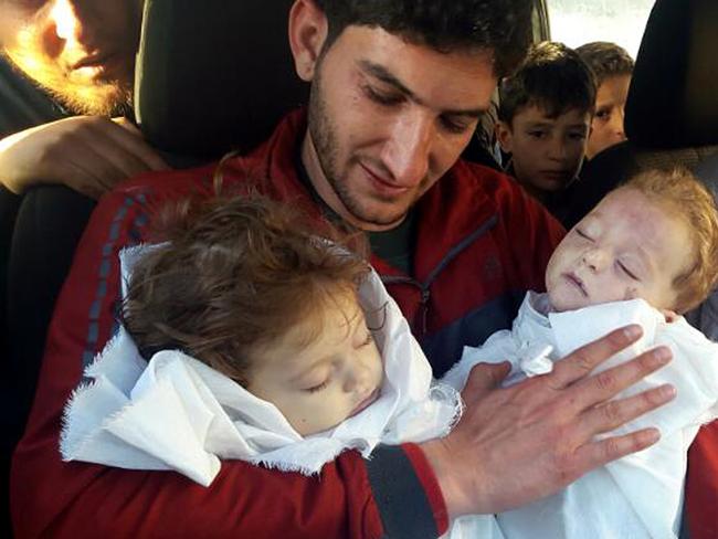 Abdul-Hamid Alyousef holds his twin babies who were killed during a chemical weapons attack, in Khan Sheikhoun in the northern province of Idlib, Syria. Picture: AP