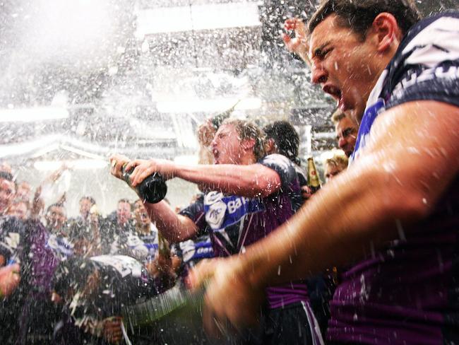 Melbourne Storm players sing their team song and celebrate in their changeroom after winning the 2009 NRL Grand Final against the Parramatta Eels. (Photo by Cameron Spencer/Getty Images)