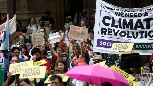 Hundreds stuck around through pouring rain at Sydney’s Town Hall to demand climate action. Picture: NCA NewsWire / Damian Shaw