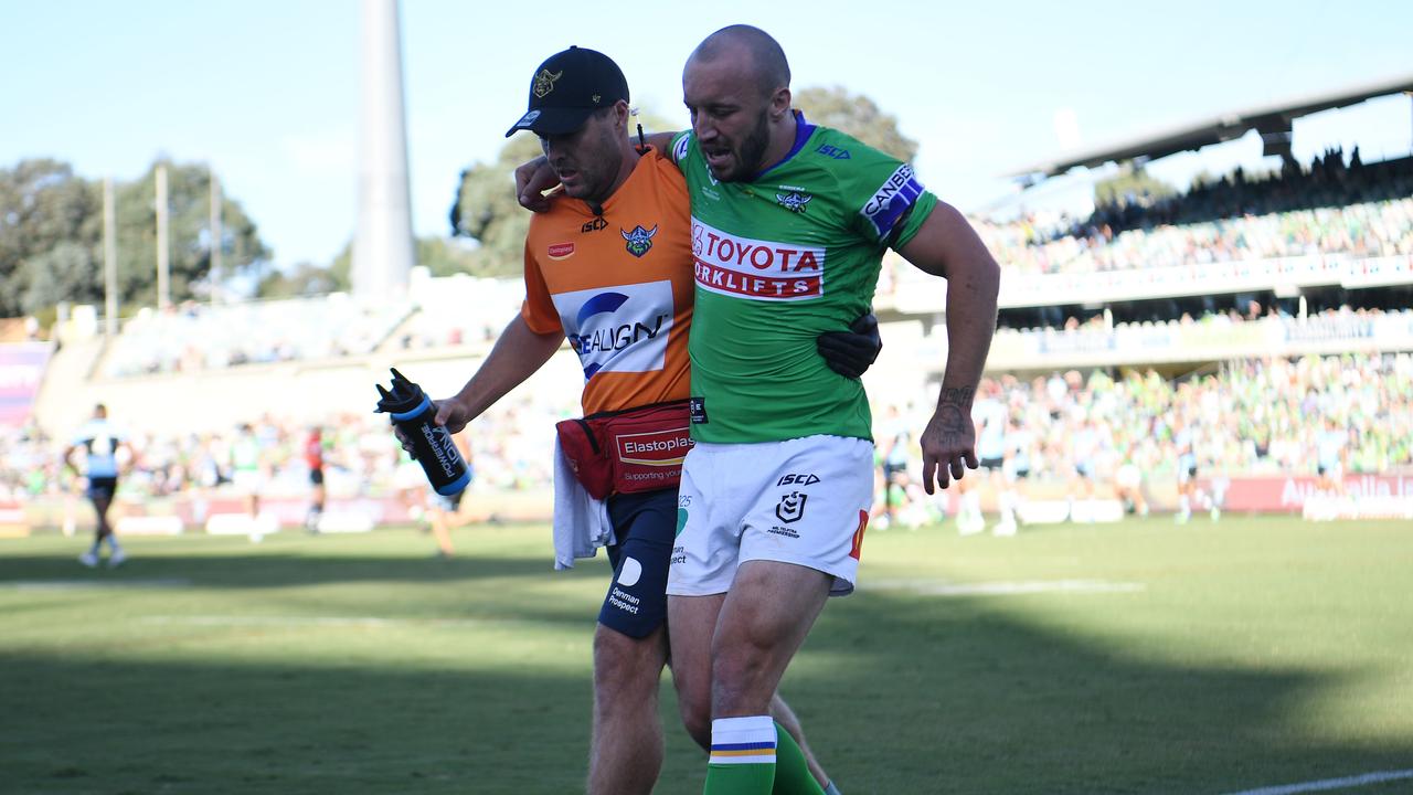 Canberra star Josh Hodgson helped off the field after suffering a knee injury. Picture: NRL Images