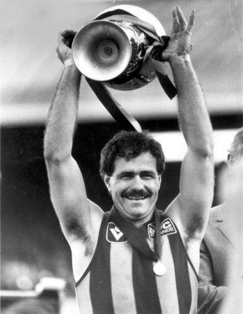 1: LEIGH MATTHEWS. Leigh Matthews poses with the trophy after Hawthorn Football Club win the VFL Grand final in 1983. 