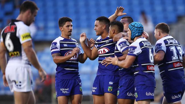 Fa'amanu Brown of the Bulldogs celebrates with team mates after scoring a try during the trial match.