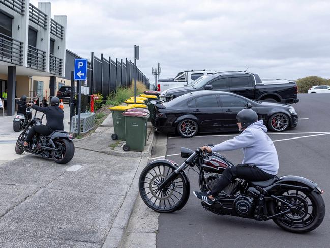 Mourners arrive on motorbikes.