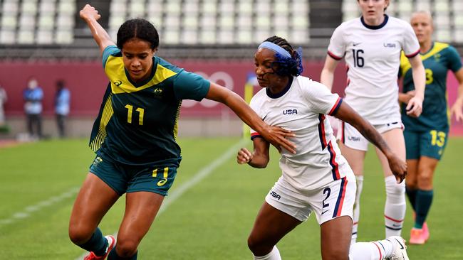 Australia's forward Mary Fowler (L) dribbles the ball past USA's defender Crystal Dunn.