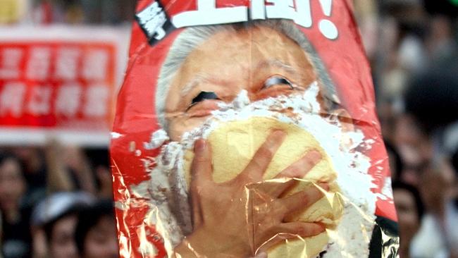 An effigy of Tung Chee-hwa crops a cream pie during the July 1, 2003, march in Hong Kong. Picture: AP