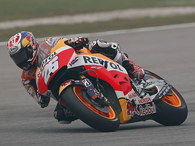 MotoGP rider Dani Pedrosa of Spain rides his Honda during the third free practice session ahead of Sunday's Malaysian Motorcycle Grand Prix at Sepang International Circuit in Sepang, Malaysia, Saturday, Oct. 24, 2015. Pedrosa took the pole position. (AP Photo/Lai Seng Sin)