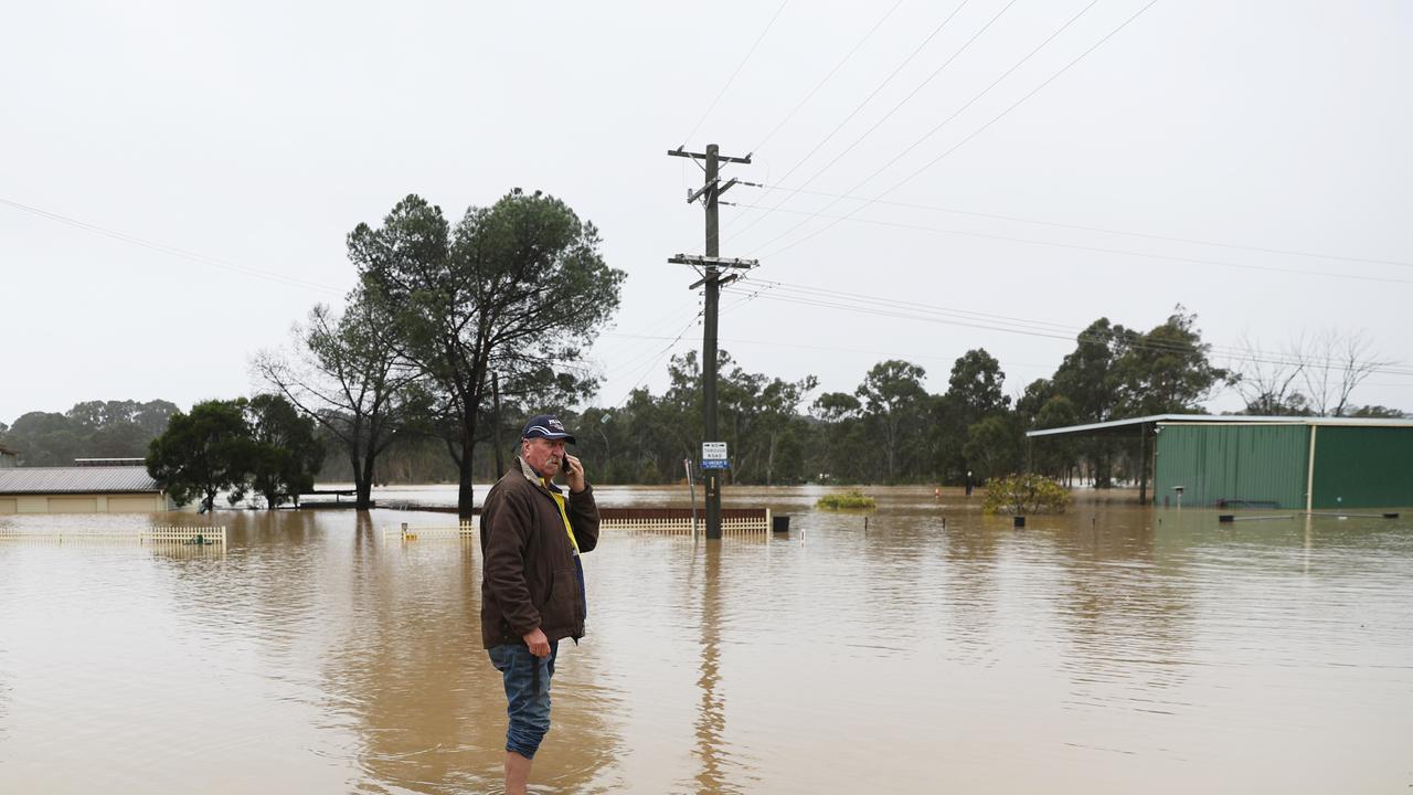 A residents of Mountview Rd looks on as his shed floods. Picture John Grainger