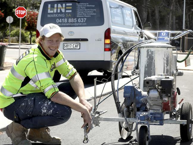 Josh Scott starred for Glenelg in the SANFL grand final. He works as a line marker and is pictured working on a bike lane in Edwardstown. 11 October 2019. Picture Dean Martin