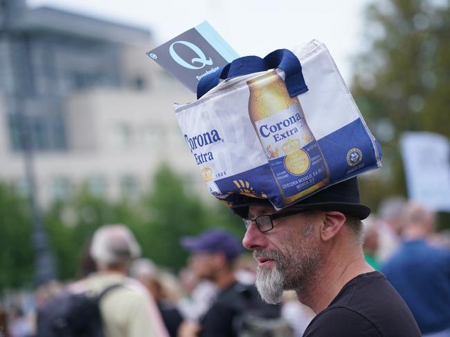 A man wearing a Corona beer bag and a Querdenker Q flag attends a gathering of coronavirus sceptics in Berlin. Picture: Sean Gallup/Getty Images