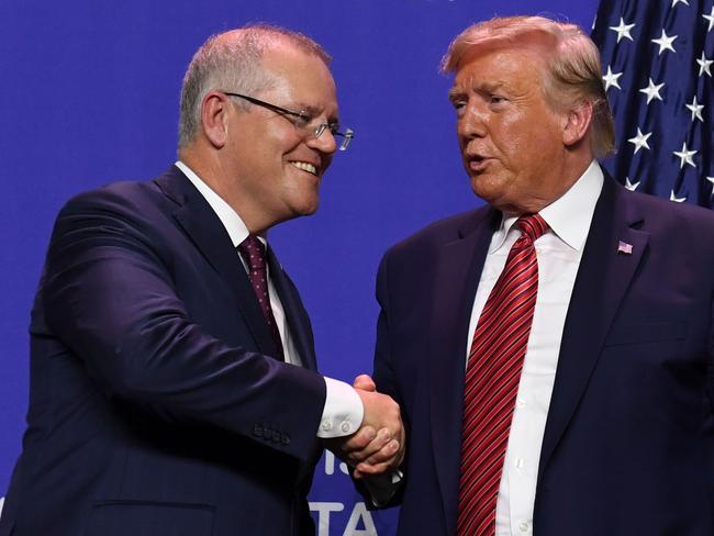 (FILES) In this file photo taken on September 22, 2019 US President Donald Trump and Australian Prime Minister Scott Morrison shake hands during a visit to Pratt Industries plant opening in Wapakoneta, Ohio. - Donald Trump asked Australia to "assist" in discrediting a Russia investigation that has clouded his presidency, with Prime Minister Scott Morrison admitting October 1, 2019 that he agreed to help.Several other calls and meetings between Trump and foreign leaders, including Russia's Vladimir Putin are now under scrutiny. Separately, the Washington Post reported that Attorney General Bill Barr has had multiple contacts with officials and spies in Australia, Britain and Italy in a bid to investigate Mueller and US intelligence findings. (Photo by SAUL LOEB / AFP)