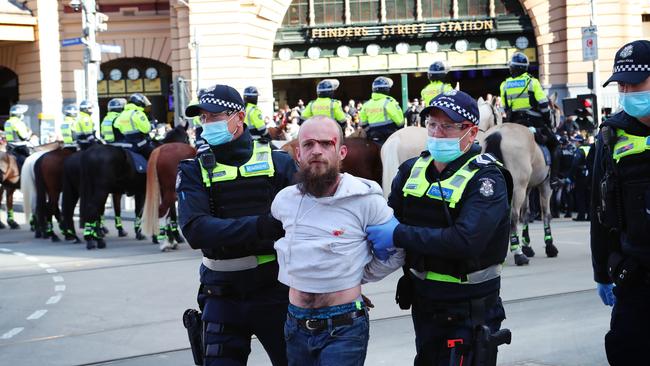 Police lead away a protester. Picture: Rebecca Michael