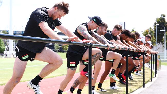 Recruits Jordan Roughead (left) and Dayne Beams warm up with teammates.