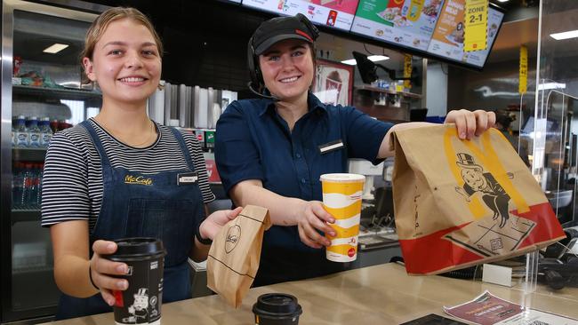 McDonald’s staff members Chelsea Pearmine and Madeline Bamblett hand out orders of coffee and a toastie and a Big Mac and coke to customers at the Gordonvale restaurant. The fast food chain is set to employ an additional 200 staff members in Far North Queensland before the busy Christmas period begins. Picture: Brendan Radke