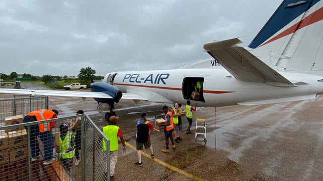 Vital supplies including groceries and medicines being unloaded in the Gulf as towns like Doomadgee and Burketown face more flooding and are cut-off by roads. Picture: QFES