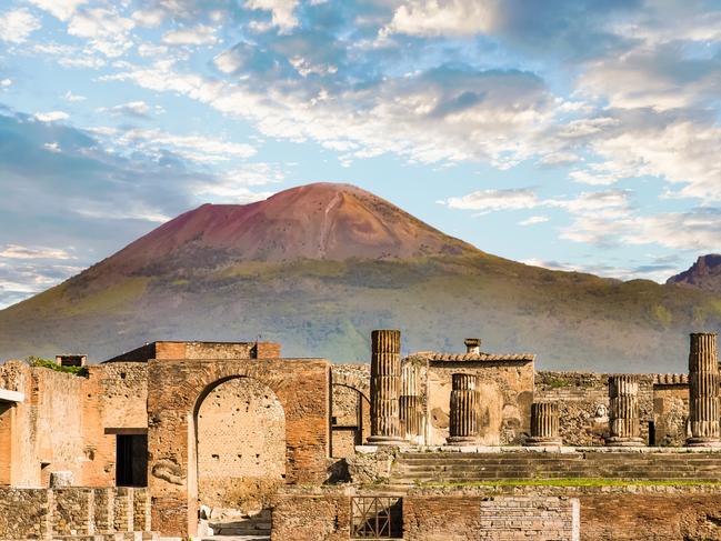 Ancient walls in Pompeii with volcano Vesuvius in the background