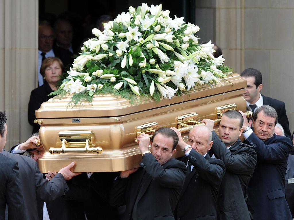 Pall bearers carry the coffin of Rosario ‘Ross’ Gangemi to a waiting hearse after his funeral at St Monica's Church in Moonee Ponds. Picture: AAP