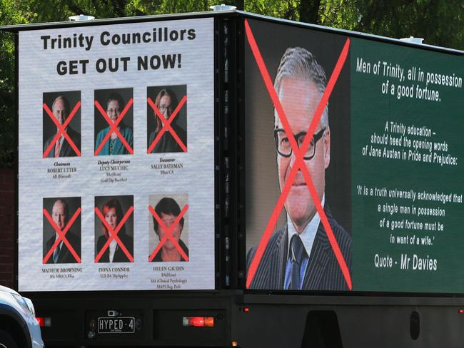 Trucks with billboards outside the Trinity Grammar school in Kew. Picture: Aaron Francis/The Australian