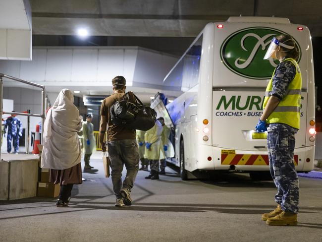 Australian citizens and visa holders evacuated from Afghanistan are assisted off their flight by Australian Defence members, NSW Health and Australian Border Force. *** Local Caption *** Evacuees from Afghanistan arrived on a flight to Australia on Friday 27 August 2021. The evacuation occurred after Australian Defence Force aircraft and personnel deployed to the Middle East Region in support of urgent government efforts to assist Australian citizens and visa holders to leave Afghanistan.