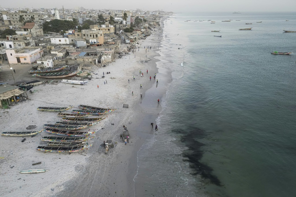 Flowers in the sand: families mourn Senegal migrants lost at sea