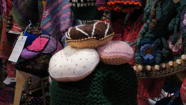 Dozens of volunteers are busy hanging thousands of beanies in preparation for the 28th Alice Springs Beanie Festival. Picture: Gera Kazakov