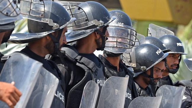 Policemen stand guard along a roadside in Karachi on May 10, 2023. Former Pakistan prime minister Imran Khan will appear on May 10 in a special court at the capital's police headquarters to answer graft charges, a day after his shock arrest prompted violent nationwide protests. Picture: AFP