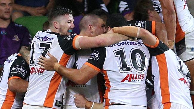 Wests Tigers players celebrate during their win over Melbourne Storm.