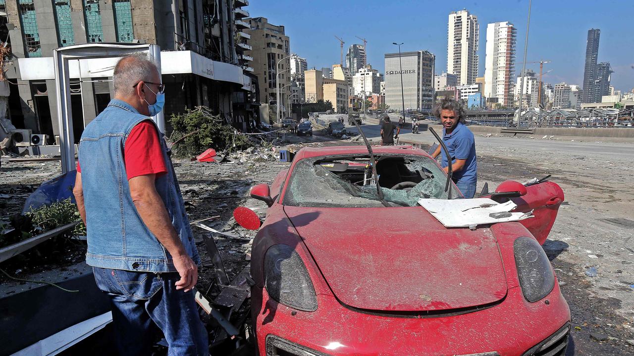 People check the damage to a car in Beirut. Picture: AFP