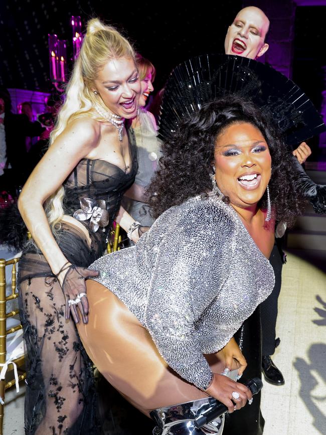 Gigi Hadid and Jordan Roth react as Lizzo performs onstage during the 2023 Met Gala.