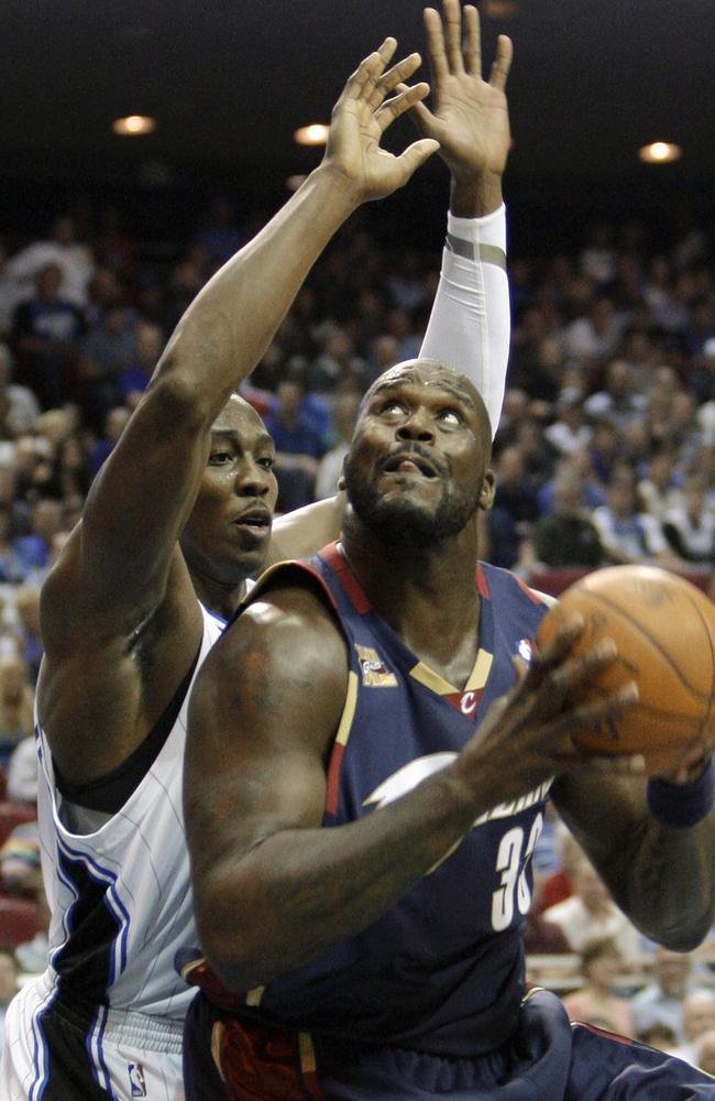 In 2009, Cleveland Cavaliers center Shaquille O'Neal, right, tries to go up for a shot against Orlando Magic center Dwight Howard.