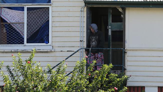 A woman leaves a squat house at Southport. Photo: Glenn Hampson