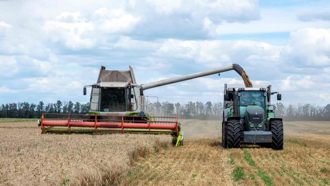 Farmers harvest a wheat field in the Ukrainian Kharkiv region amid Russian invasion of Ukraine. Picture: AFP