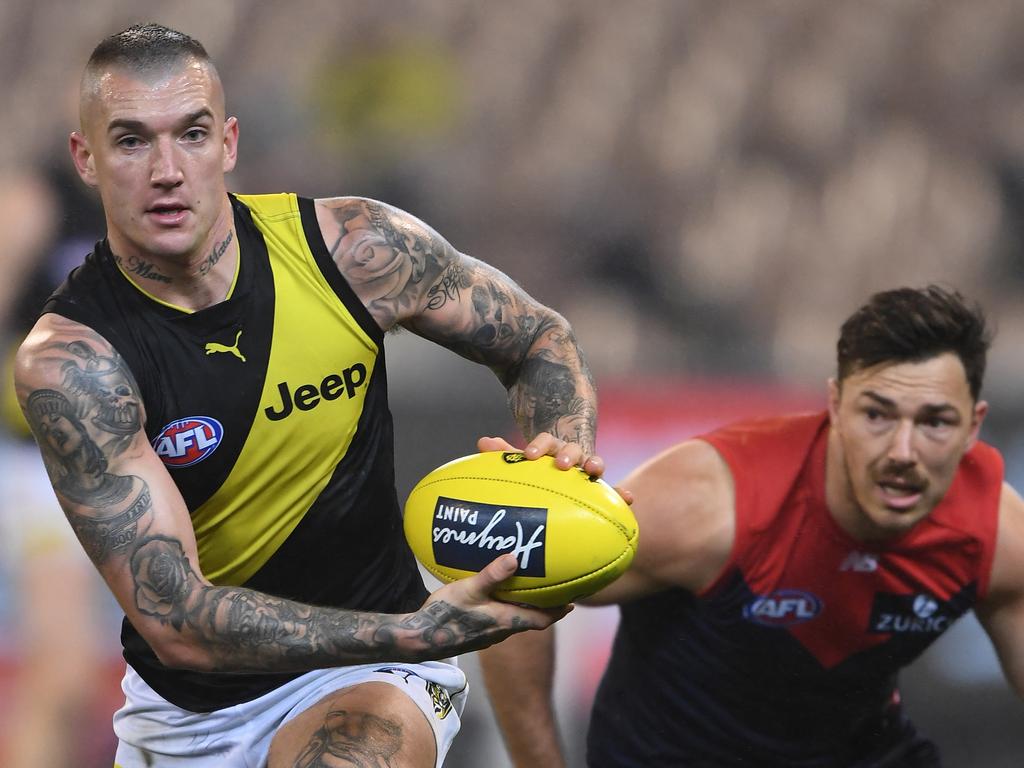 Dustin Martin of the Tigers (left) and Michael Hibberd of the Demons contest during the Round 20 AFL match between the Melbourne Demons and the Richmond Tigers at the MCG in Melbourne, Saturday, August 3, 2019.  (AAP Image/Julian Smith) NO ARCHIVING, EDITORIAL USE ONLY