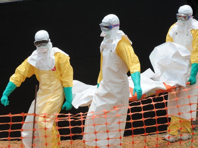 Doctors without Borders (Medecin sans frontieres) carry the body of a person killed by viral haemorrhagic fever. The WHO has reported a 63 per cent jump in zoonotic disease. Picture: AFP