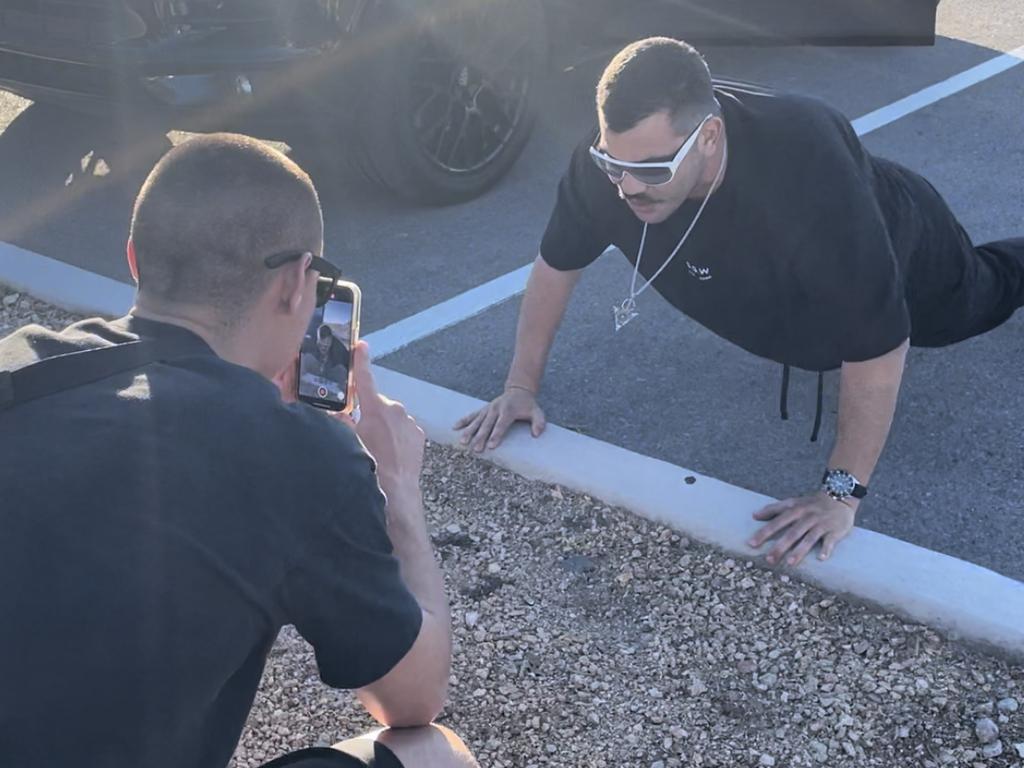 Tszyu films Omar’s first set of push-ups in the Speed Vegas carpark. Picture: Brendan Bradford