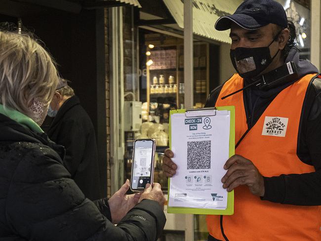 MELBOURNE, AUSTRALIA - JUNE 18: A person scans a QR code before entering the South Melbourne Market as lockdown restrictions ease on June 18, 2021 in Melbourne, Australia. Covid-19 related lockdown restrictions eased further today across Victoria including permitting gyms and indoor entertainment venues to open, and allowing Melbournians to travel to regional Victoria. (Photo by Daniel Pockett/Getty Images)