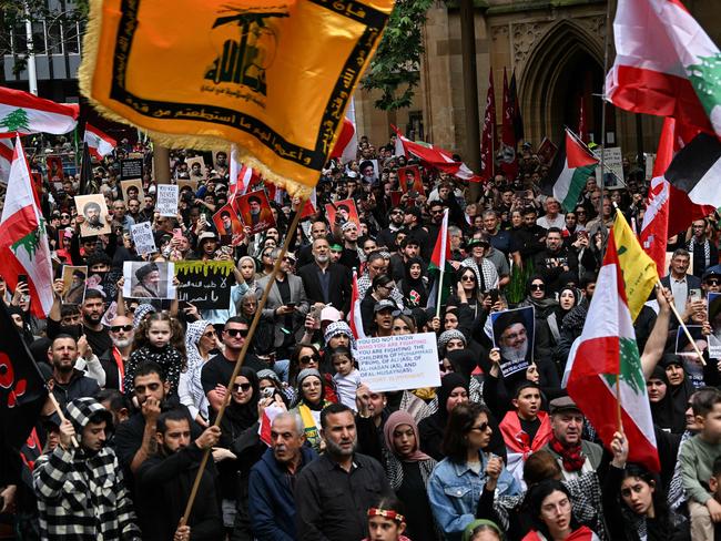 Hundreds of demonstrators hold flags and pictures of Hassan Nasrallah, late leader of the Lebanese group Hezbollah, at a protest rally in the central business district of Sydney on September 29, 2024. (Photo by Saeed KHAN / AFP)