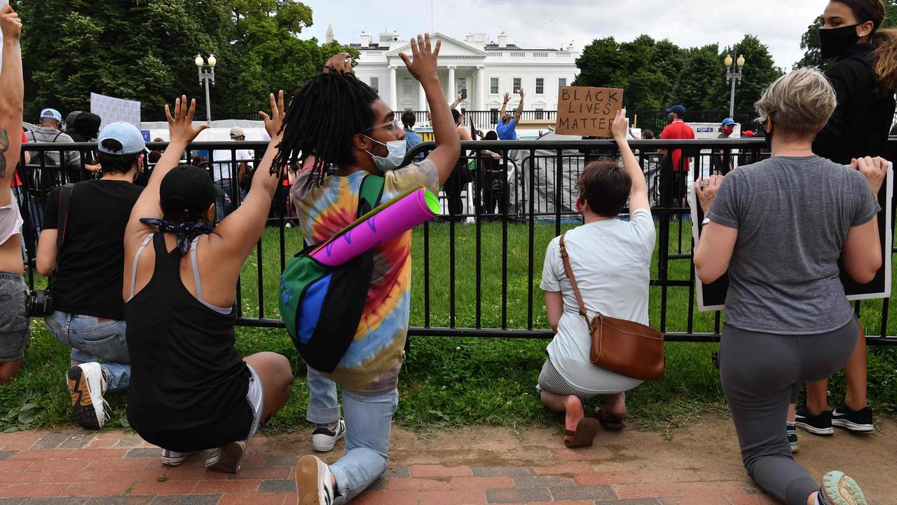 Protesters kneel as they gather outside the White House. Picture: Nicholas Kamm / AFP