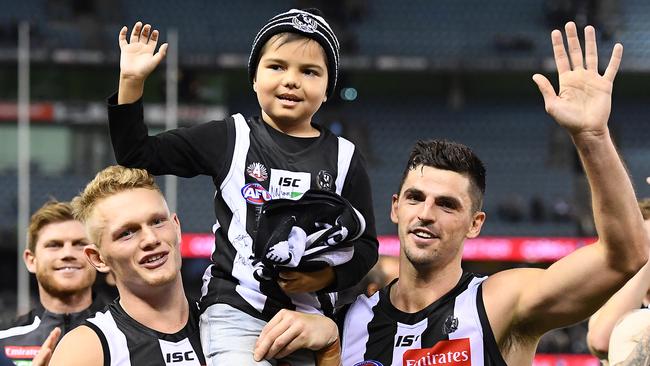 Young Pie fan and brain cancer sufferer Kyron McGuire gets chaired off the ground by favourite player Adam Treloar and Collingwood captain Scott Pendlebury in Round 7. Picture: Getty Images