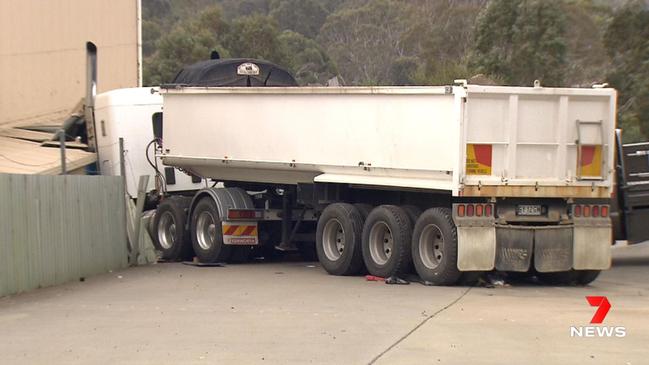 The runaway semi-trailer after it ploughed into the workplace shed. Picture: 7NEWS