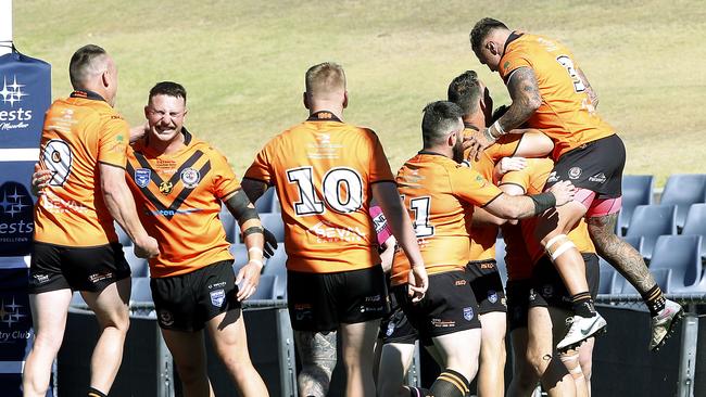 Prop Tony Campbell swamped by teammates after scoring a try. Picture: John Appleyard