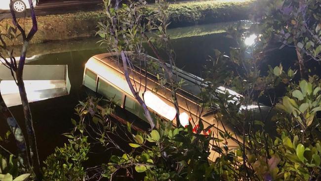 Police rescued a driver whose bus had crashed into a croc-inhabited creek in Cairns. PHOTO: Queensland Police