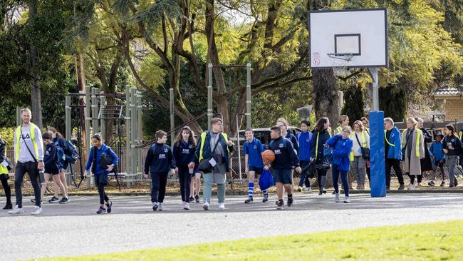 Students return to East Adelaide School in St Peter’s, after families were advised to keep children at home after it received a bomb threat via email. Picture: Emma Brasier