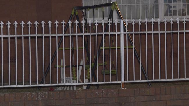 A swing set and children’s bikes were seen in the front yard of the home where a woman was found dead. Picture: TNV