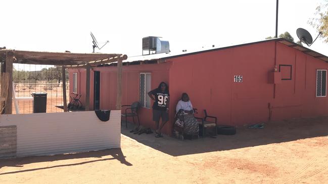 Enid Young (seated) at the Santa Teresa mission in the Northern Territory. The NT Civil and Administrative Tribunal ordered the government to pay almost $15,000 in compensation to four people from the Red Centre community due to poor housing conditions and for renting homes that were uninhabitable. Source: Grata Fund