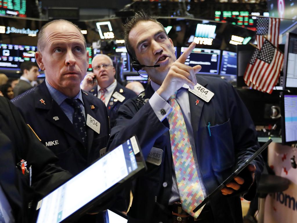 Traders work on the floor of the New York Stock Exchange on April 25 where Microsoft shares topped estimates. Picture: AP Photo/Richard Drew, File