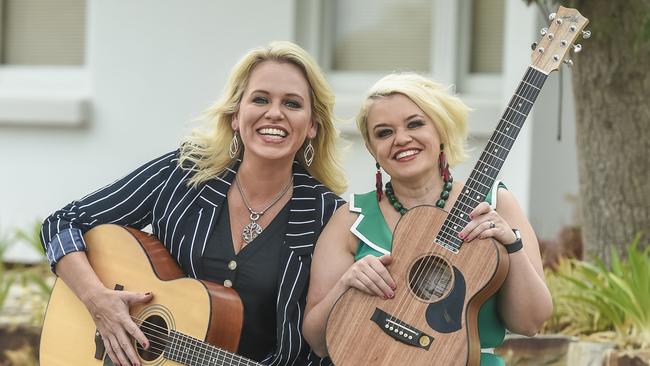 Golden Guitar winner Beccy Cole, left, and wife Libby O’Donovan are celebrating their first year of marriage with a trip to the AFLW footy. Picture: Roy VanDerVegt